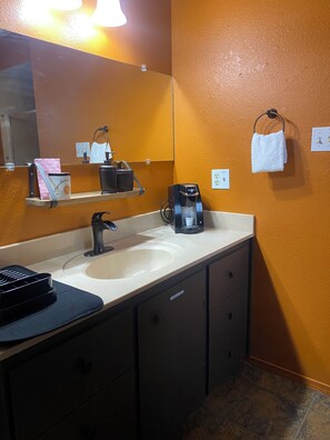 A bathroom with a sink, mirror, towel rack, and a coffee maker. - HIKERS HIDEOUT IN WEST SEDONA  (Sedona)