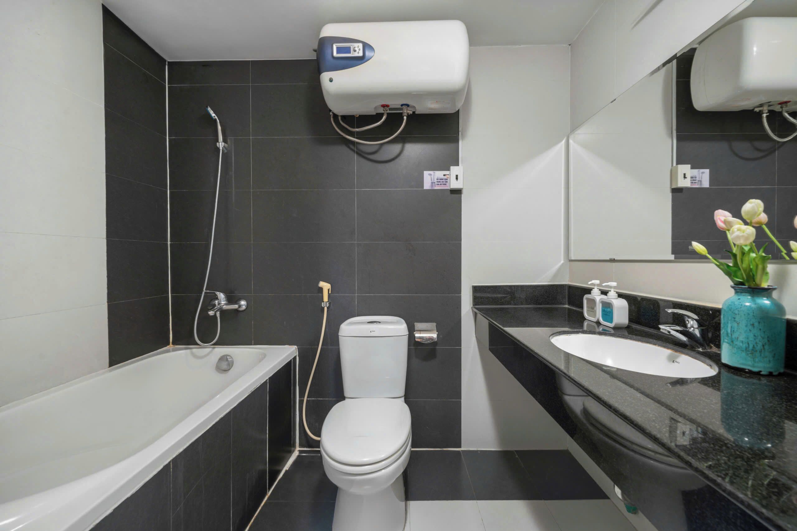 A modern bathroom with a bathtub, toilet, and sink.