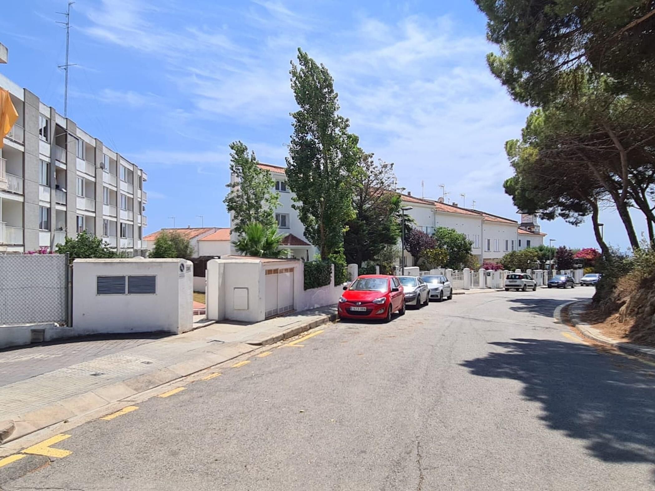 A street with parked cars and buildings.
