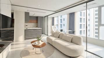 A modern living room with a sofa, a coffee table, and a TV.