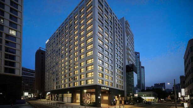 A high-rise hotel with a modern design, multiple floors, and a prominent entrance. - UH FLAT THE SEOCHO (Seoul)