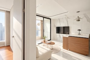 A modern living room with a sofa, coffee table, and a TV mounted on the wall. - UH FLAT THE SEOCHO (Seoul)