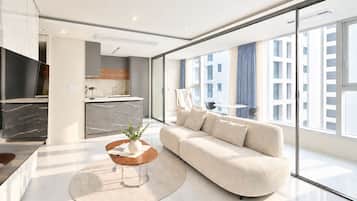 A modern living room with a sofa, coffee table, and a TV.