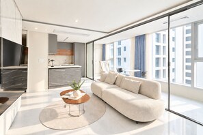 A modern living room with a sofa, coffee table, and a TV.