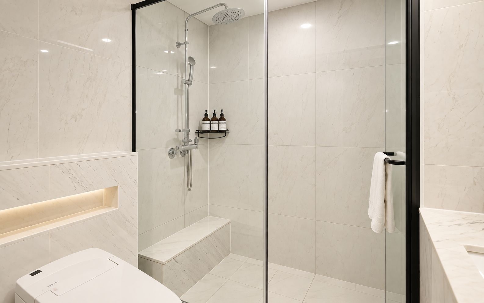 A modern bathroom with a glass-enclosed shower, a white sink, and a towel rack.