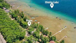 An aerial view of Higgins Lake with a marked house and beach area. - Beautiful Home w/ 2 fireplaces, Deck, and 75ft of Private Higgins Lake Frontage (Roscommon)