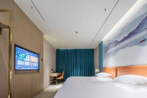 A hotel room with a bed, a desk, a TV, and a mural on the wall. - Shangcheng Pusu Hotel (Wenzhou)