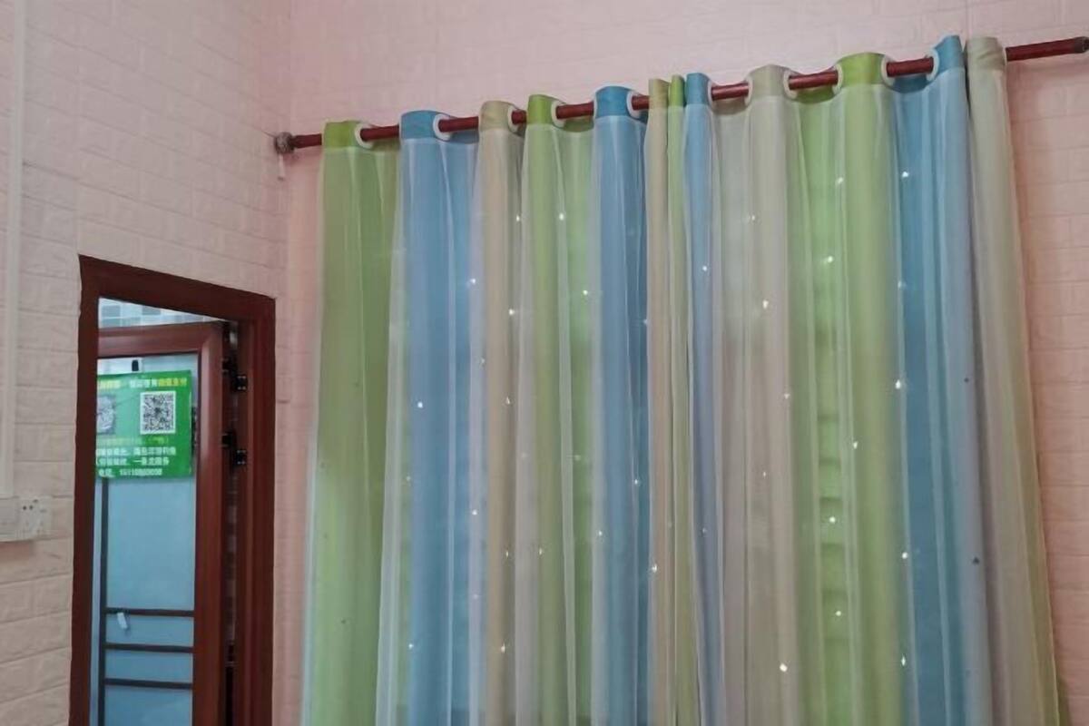 A room with a curtain featuring vertical stripes in various colors.