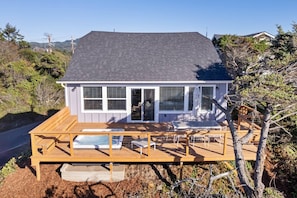 Enjoy the elevated deck with a sliding glass door leading to an enclosed patio area.