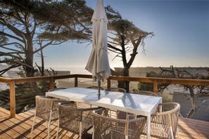 Relax on the deck overlooking the water with a comfortable table and chairs.