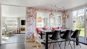 A dining area with a table, chairs, and a mirror. - "Sveina" - 600m from the sea by Interhome (Hadsund)