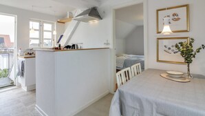 A compact, well-lit room with a kitchenette, a dining area, and a bed. - "Evangelina" - 350m from the sea by Interhome (Løkken)