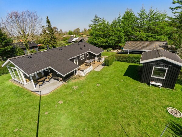 A residential property with a large house, a detached garage, and a small shed.