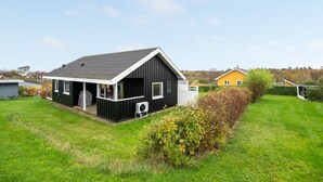 A modern black house with a covered porch and a small garden. - "Clarita" - 300m to the fjord by Interhome (Roslev)