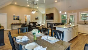 A spacious kitchen with a dining area, wooden furniture, and a ceiling fan. - Charming Pendleton Retreat ~ 5 Mi to Clemson! (Pendleton)