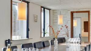 A conference room with a long table, chairs, and wine glasses. - "Rahild" - 2km to the fjord by Interhome (Thyholm)