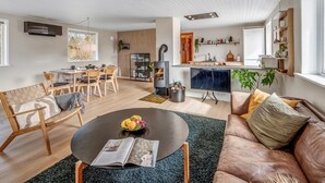 Un salon moderne avec un canapé, une table basse et un coin repas.