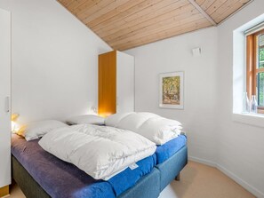 A bedroom with a bed, a window, and a painting on the wall. - "Thormar" - 1.5km from the sea by Interhome (Blåvand)