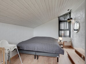 A modern bedroom with a large bed, a desk, and a chair. - "Kadife" - 750m from the sea by Interhome (Saltum)