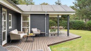 A covered patio with outdoor furniture, a wooden deck, and a lawn. - "Onta" - 900m from the sea by Interhome (Blokhus)