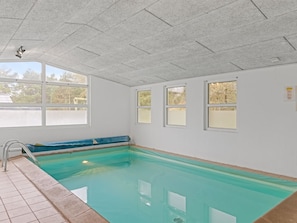 An indoor swimming pool with clear glass walls, a tiled floor, and a metal ladder. - "Ingebore" - 700m from the sea by Interhome (Løkken)