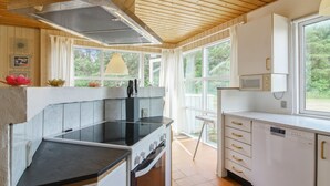 A modern kitchen with wooden ceiling, large windows, and white cabinetry. - "Frellef" - 491m from the sea by Interhome (Løkken)