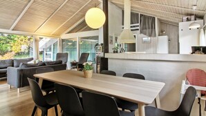 A modern kitchen with a central island, wooden ceiling, and large windows. - "Kragh" - 950m from the sea by Interhome (Løkken)