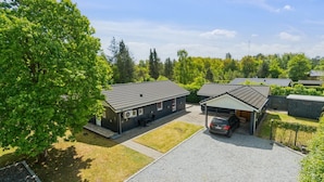 A residential area with multiple houses, a gravel driveway, and a car parked in front of one house. - "Letizia" - 700m from the sea by Interhome (Hals)
