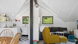 A cozy loft-style living space with a kitchen, dining area, and seating area.