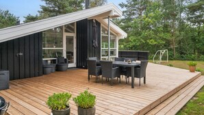 A modern house with a deck, outdoor seating, and a large window. - "Ove" - 500m from the sea by Interhome (Hals)