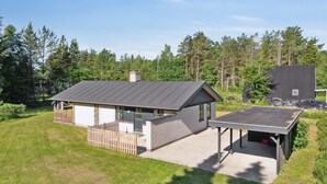 A modern house with a large deck, a covered outdoor area, and a garage. - "Henny" - 1.5km from the sea by Interhome (Hals)
