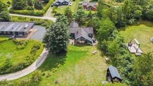 An aerial view of a residential area with houses, a large tree, and a body of water in the background. - "Etel" - 600m from the sea by Interhome (Ebeltoft)