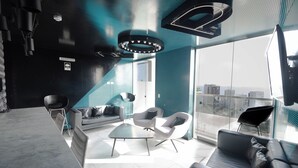 A modern living room with a large window, a sofa, two armchairs, and a coffee table. - 3BedRoom APT in the HEART of BARRANCO, LIMA, PERU 🇵🇪 (Barranco)
