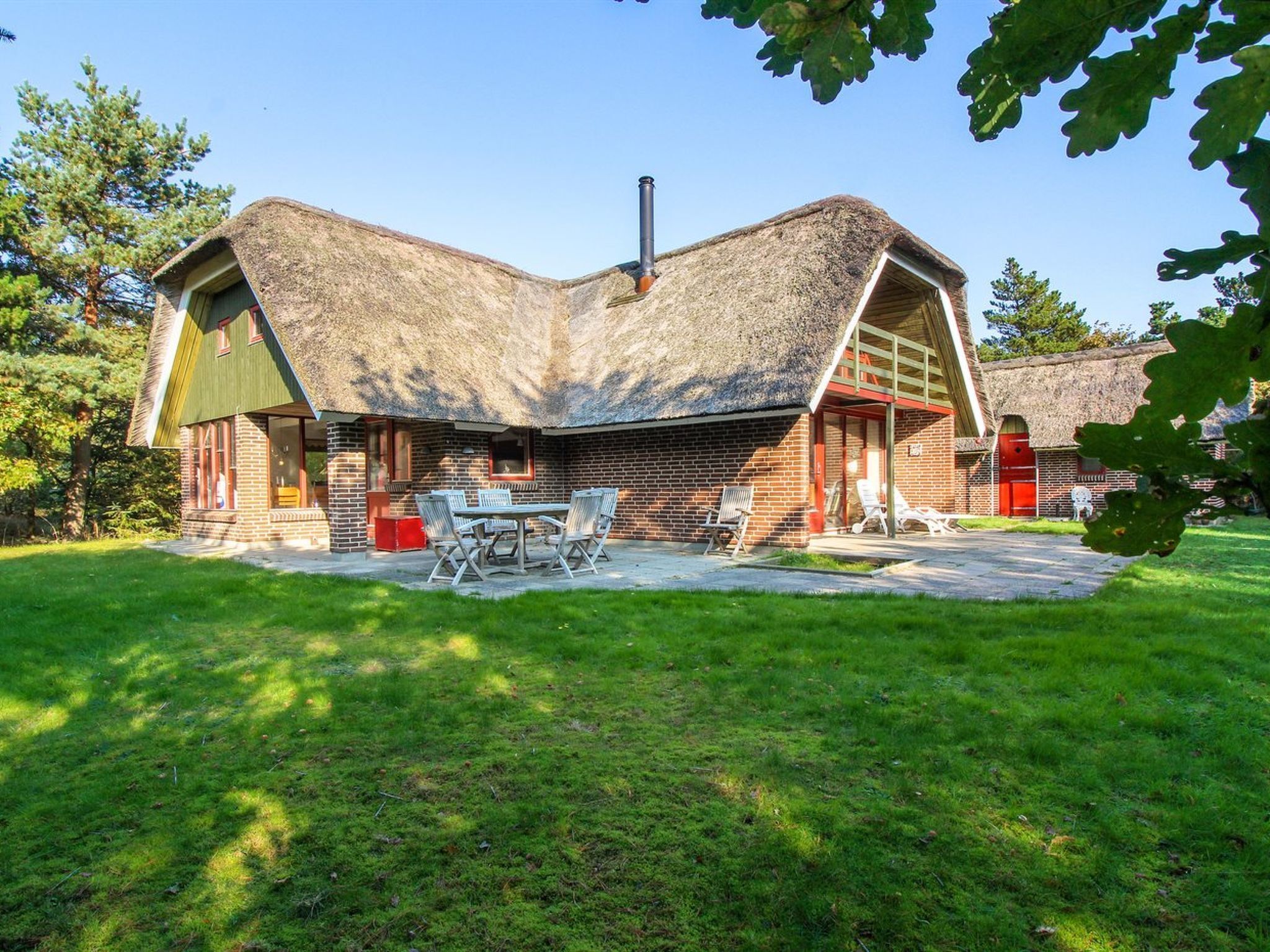 A house with a unique curved roof and brick exterior.