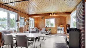 A modern interior with a wooden ceiling, a dining area, a seating area, and a fireplace. - "Absolon" - 1.5km from the sea by Interhome (Blåvand)