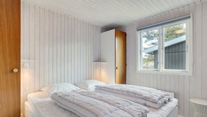 A bedroom with a bed, a window, and a small table. - "Absolon" - 1.5km from the sea by Interhome (Blåvand)