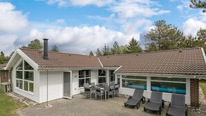 A two-story house with a patio area, a swimming pool, and a small play area. - "Rudy" - 900m to the fjord by Interhome (Blåvand)