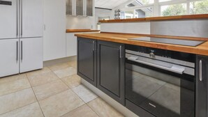 A modern kitchen with a built-in oven, a dishwasher, and a double-door refrigerator.
