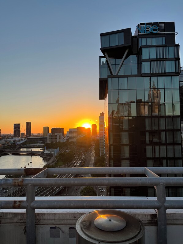 Experience the city from a high-rise perspective with a balcony offering views of the surrounding urban skyline.