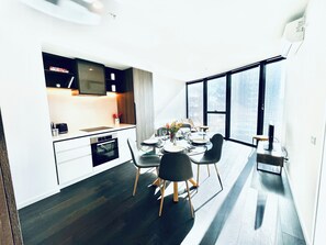 Enjoy a functional and stylish living space with a kitchenette, dining area, and city view.