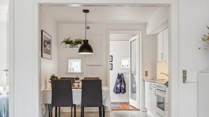 A modern kitchen with white cabinets, a countertop, and a hanging light fixture. - "Withulf" - 2.3km from the sea by Interhome (Rømø)