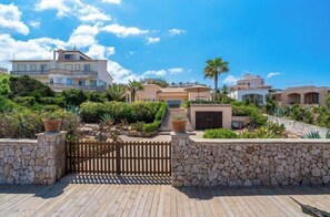 Enjoy expansive views from multiple levels with balconies, surrounded by serene gardens and palm trees.