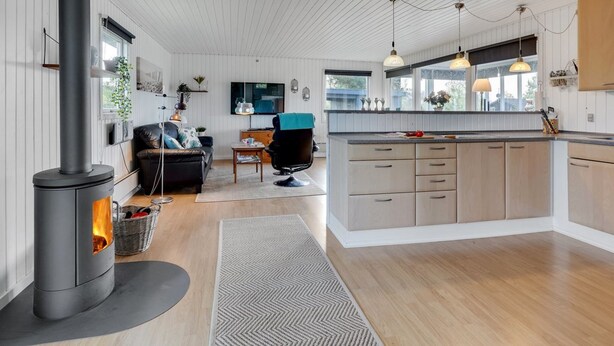 A modern kitchen with a central island, wooden cabinets, and pendant lighting. - "Ilene" - 1km from the sea by Interhome (Bogø By)