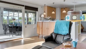A modern living room with a leather sofa, a wooden coffee table, and a dining area with a table and chairs. - "Ilene" - 1km from the sea by Interhome (Bogø By)