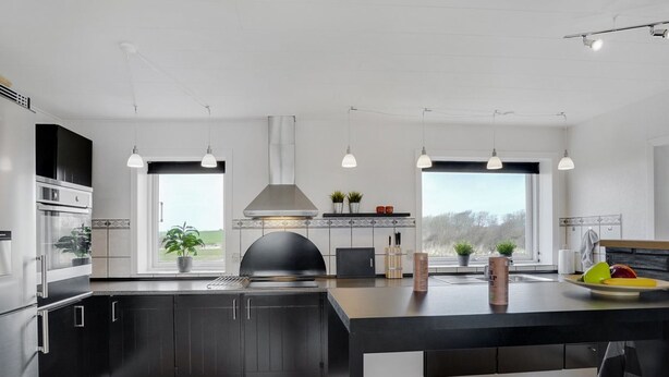 A modern kitchen with a central island, pendant lighting, and large windows. - "Imilie" - 250m to the fjord by Interhome (Redsted Mors)