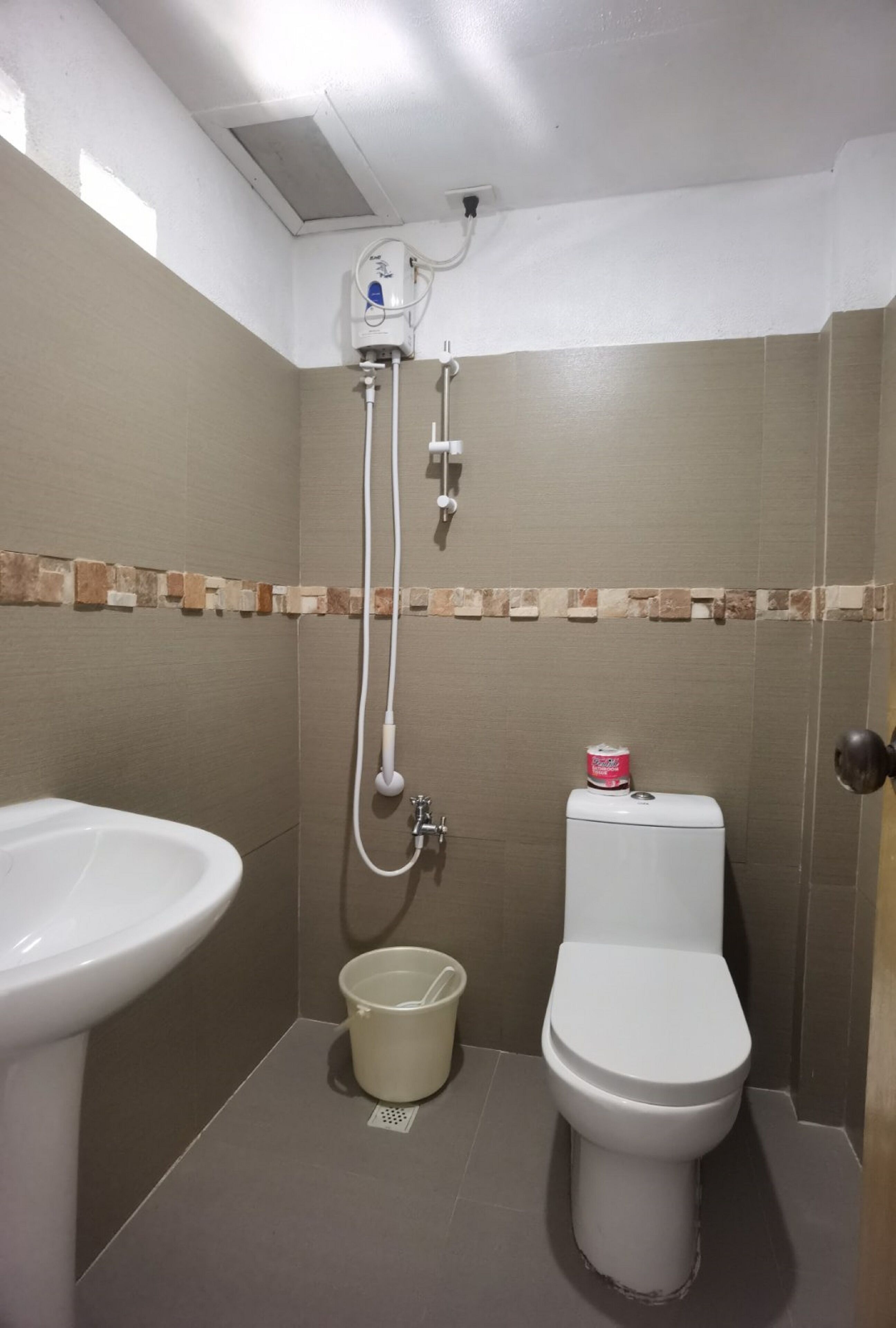 A bathroom with a toilet, a sink, and a shower.