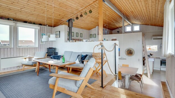 A spacious living area with a high wooden ceiling, a sofa, a dining table, and a kitchen area visible in the background. - "Kulle" - 200m from the sea by Interhome (Saltum)