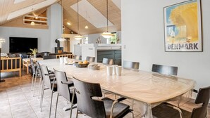 A modern kitchen with a large island, wooden ceiling beams, and a Denmark-themed wall art. - "Benthe" -  from the sea by Interhome (Ulfborg)