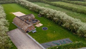 A thatched-roof house with a patio and a small garden. - "Benthe" -  from the sea by Interhome (Ulfborg)