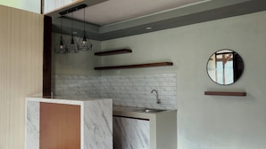 A modern kitchen with a marble countertop, a built-in sink, and pendant lighting. - Pijar Resort Powered by Cocotel (Colo)